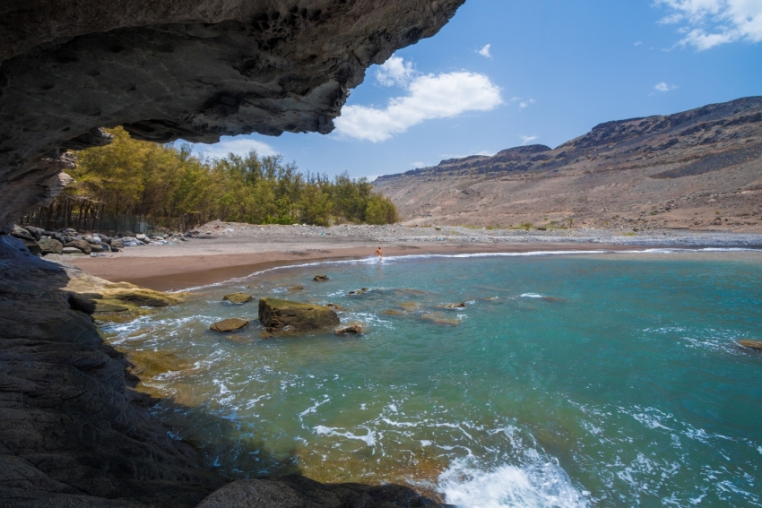 veneguera beach view from a cave